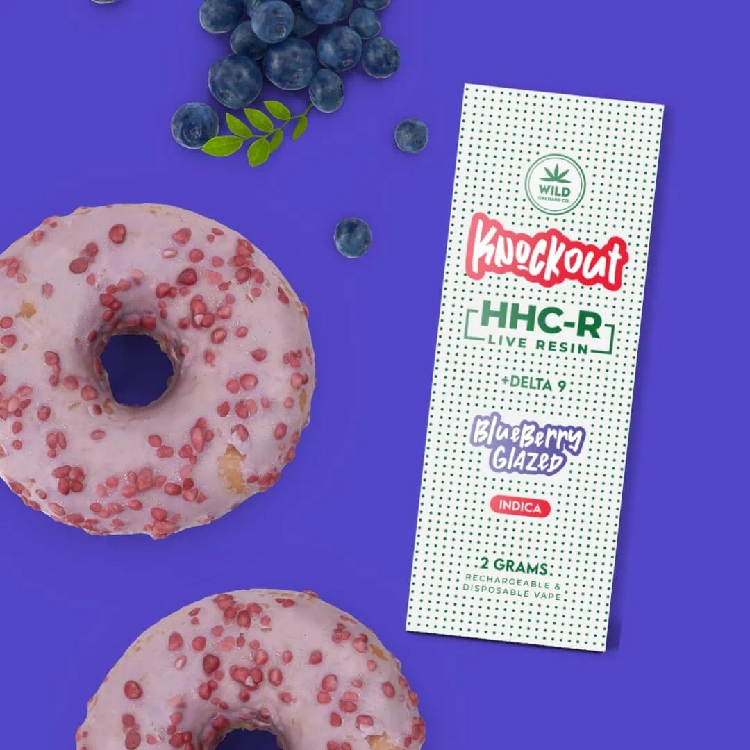 Knockout “Strawberry Sprinkles” HHC-R Live Resin Vape 2 Gram donuts and blueberries on a purple background.