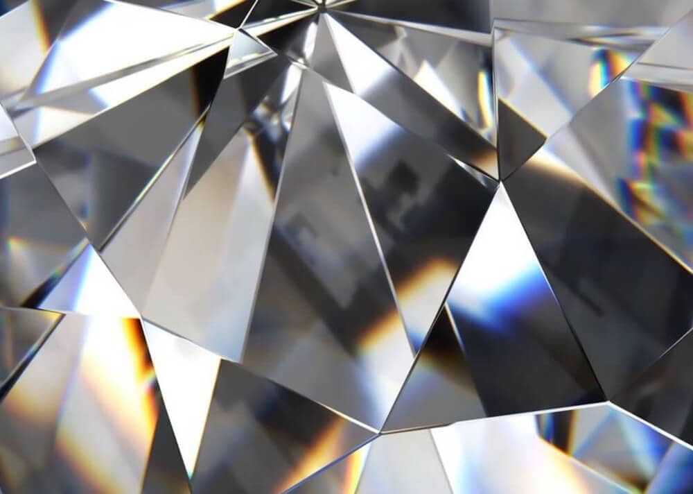 Close-up of a multifaceted crystal surface reflecting light.