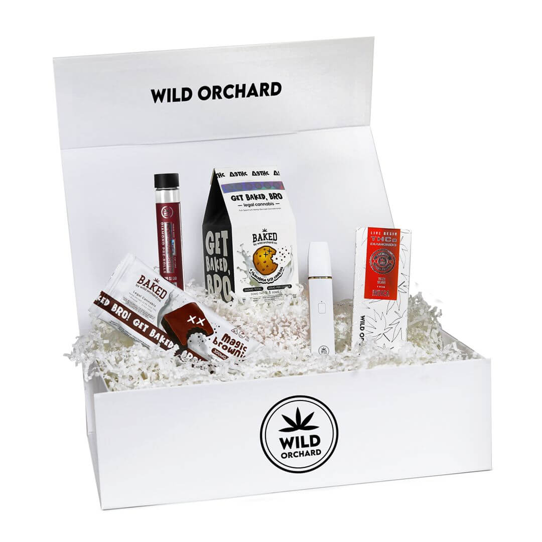 A [Mixed Bundle] from wild orchard featuring assorted hemp-based products like tinctures, balms, and pre-rolled items, arranged on white crinkle paper.